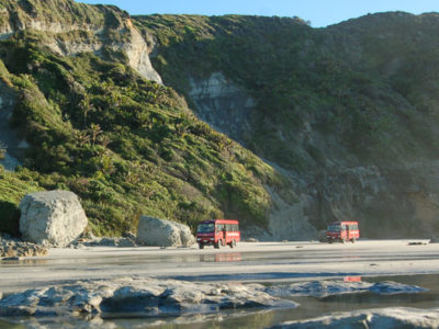 Farewell Spit Eco Tour buses on beach